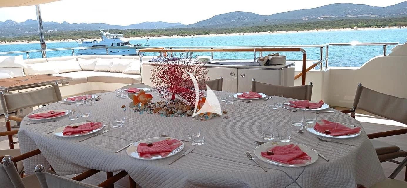 a table set for a dinner on a beach aboard ASLEC 4 Yacht for Sale