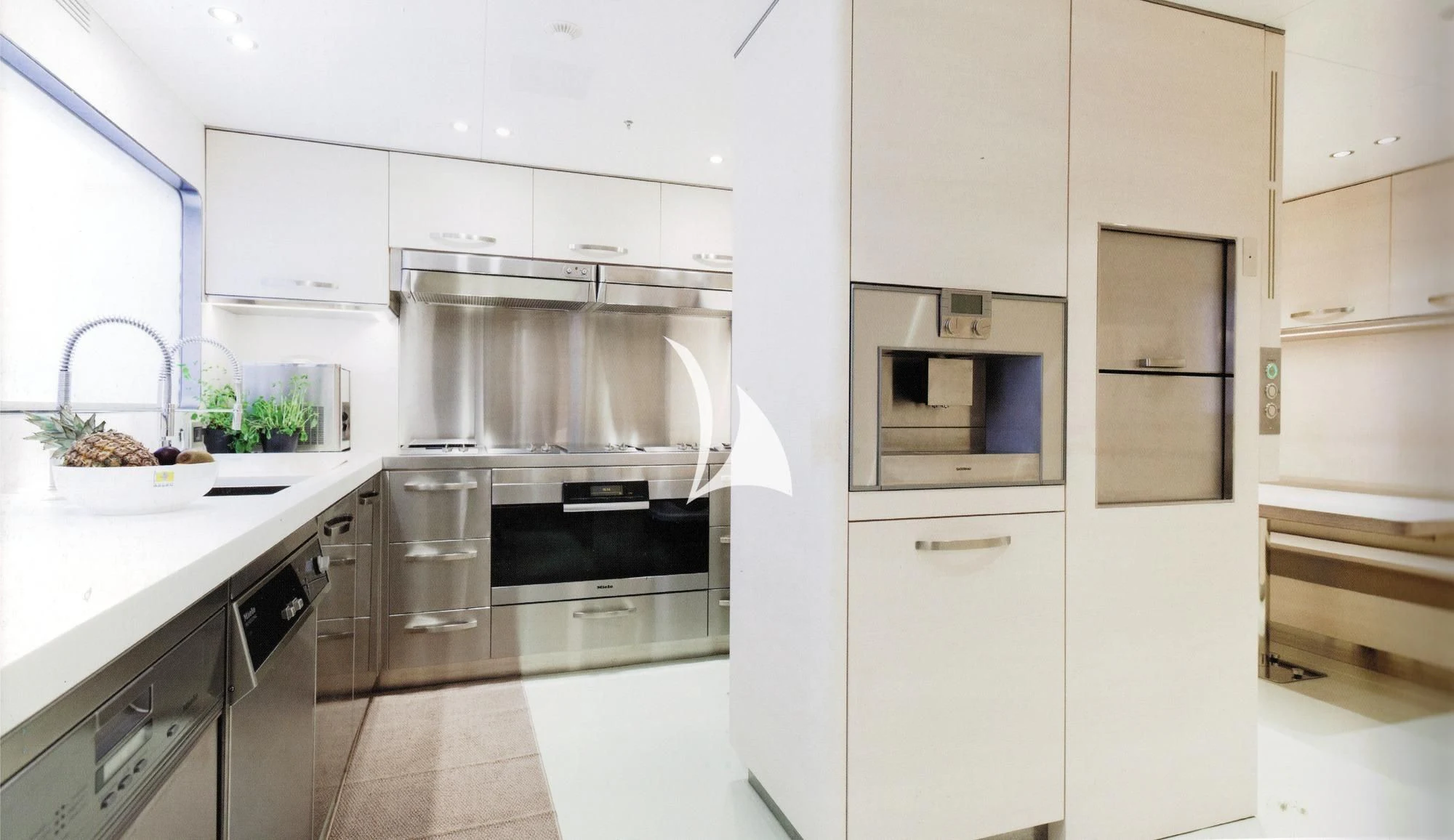 a kitchen with white cabinets aboard ASLEC 4 Yacht for Sale
