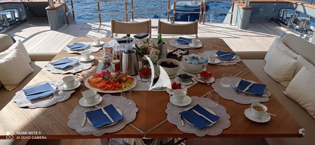 a table with plates and cups on it aboard ASLEC 4 Yacht for Sale