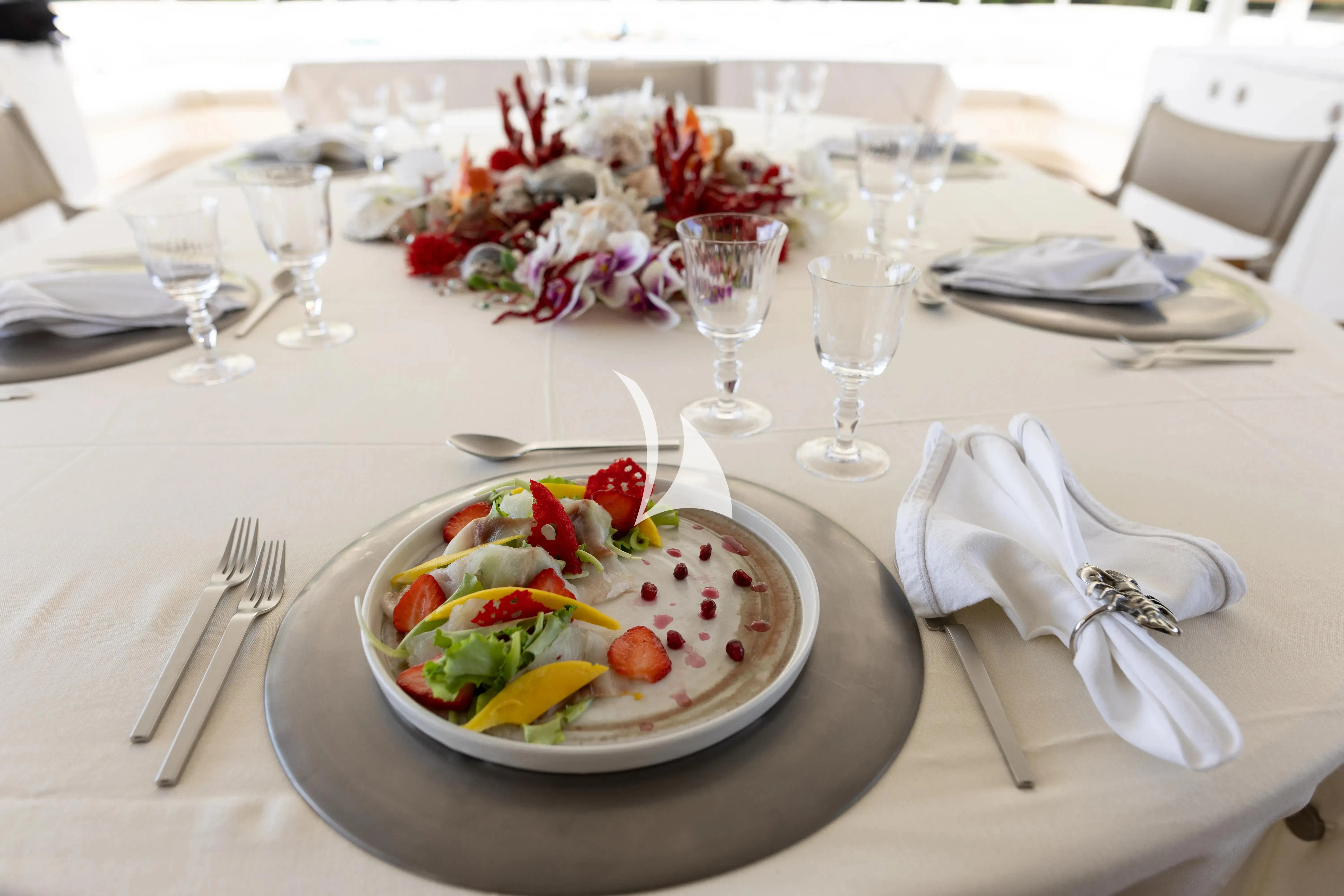 a plate of food and silverware on a table aboard ASLEC 4 Yacht for Sale