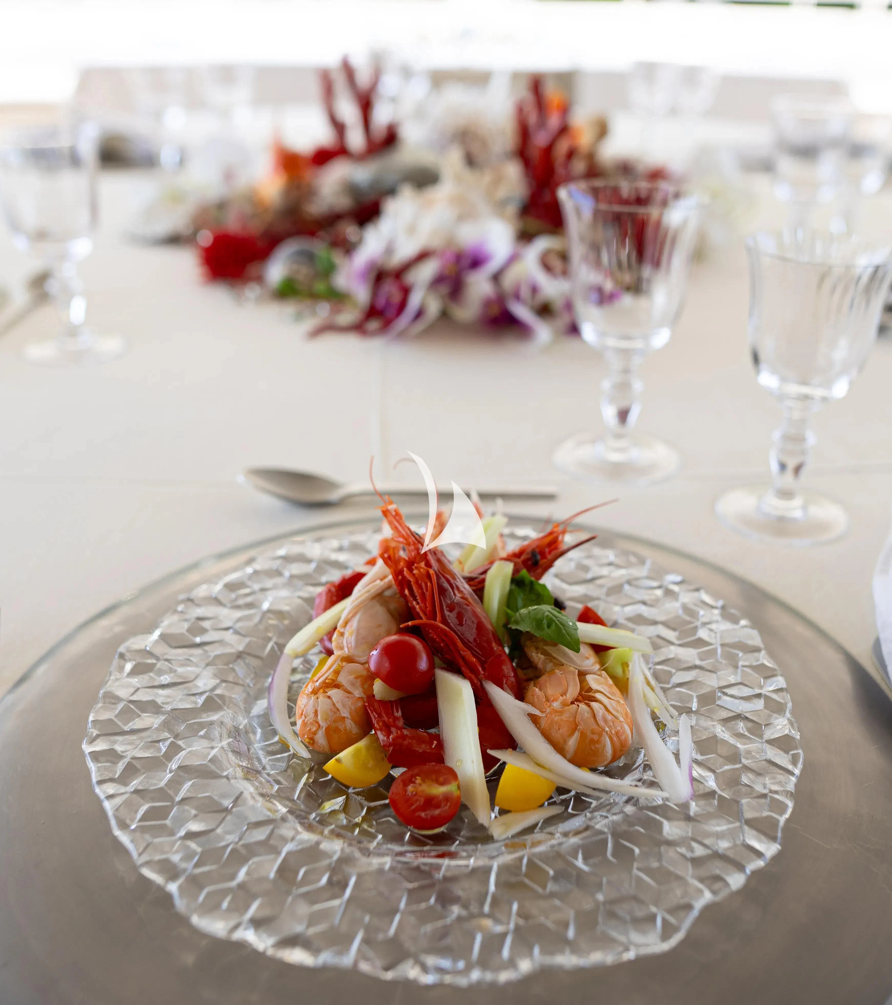 a plate of food and glasses aboard ASLEC 4 Yacht for Sale
