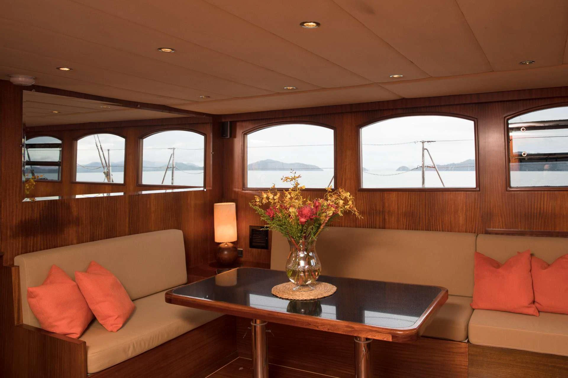 a living room with a table and couches aboard THE BLUE Yacht for Sale