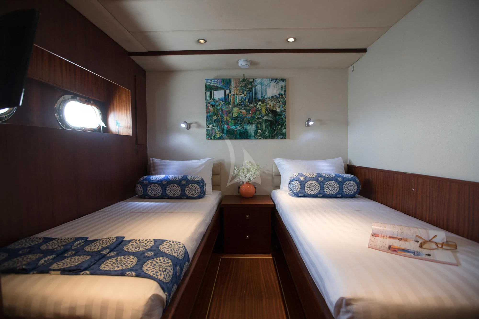 a bedroom with two beds aboard THE BLUE Yacht for Sale