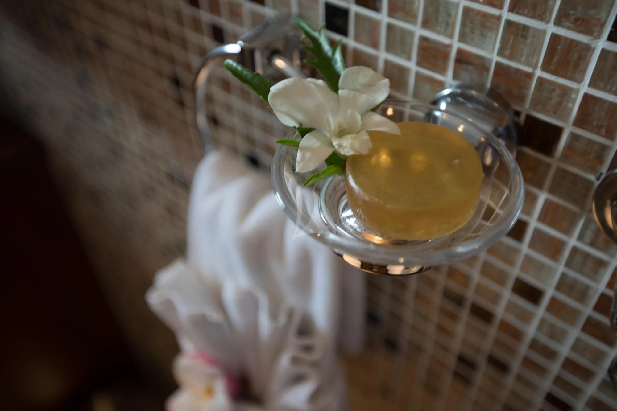 a glass of liquid with flowers on a table aboard THE BLUE Yacht for Sale