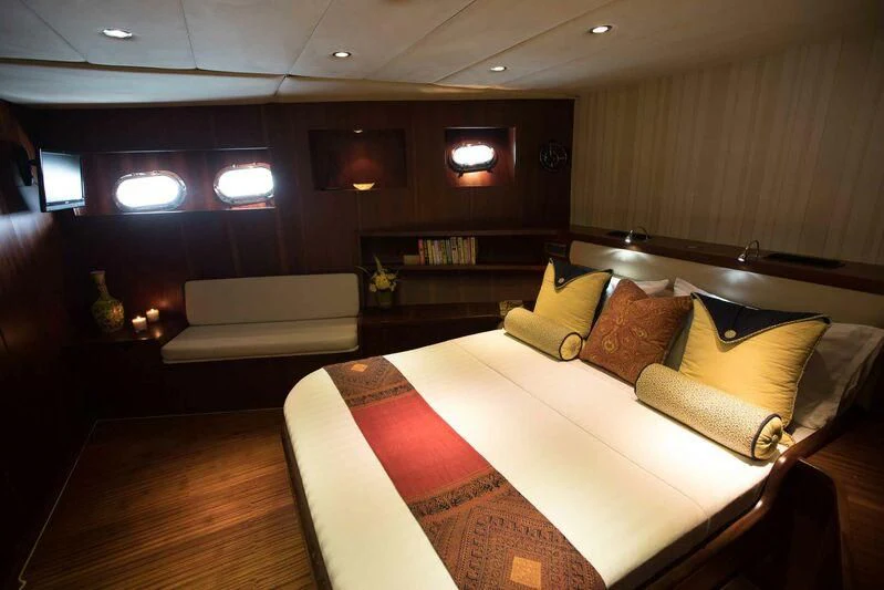 a room with a bed and a couch aboard THE BLUE Yacht for Sale