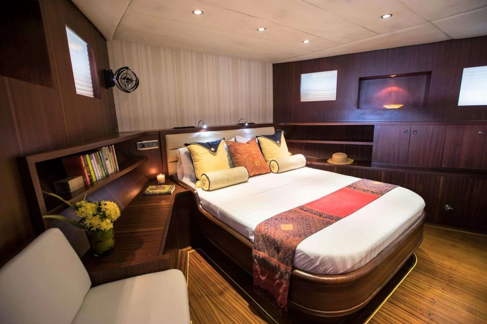 a room with a bed and a table aboard THE BLUE Yacht for Sale