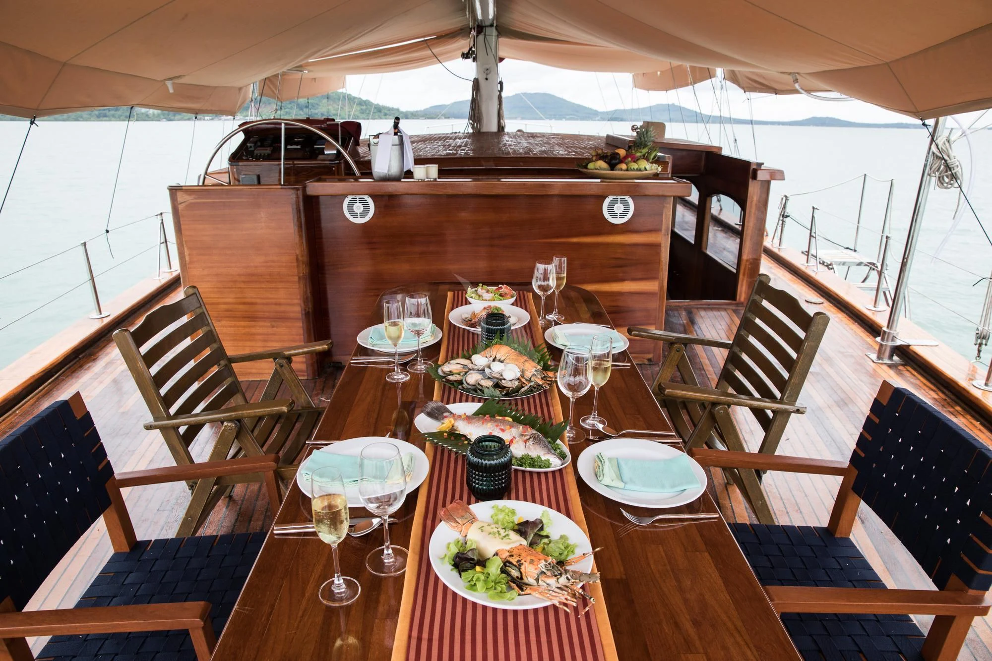 a table with food and wine aboard THE BLUE Yacht for Sale
