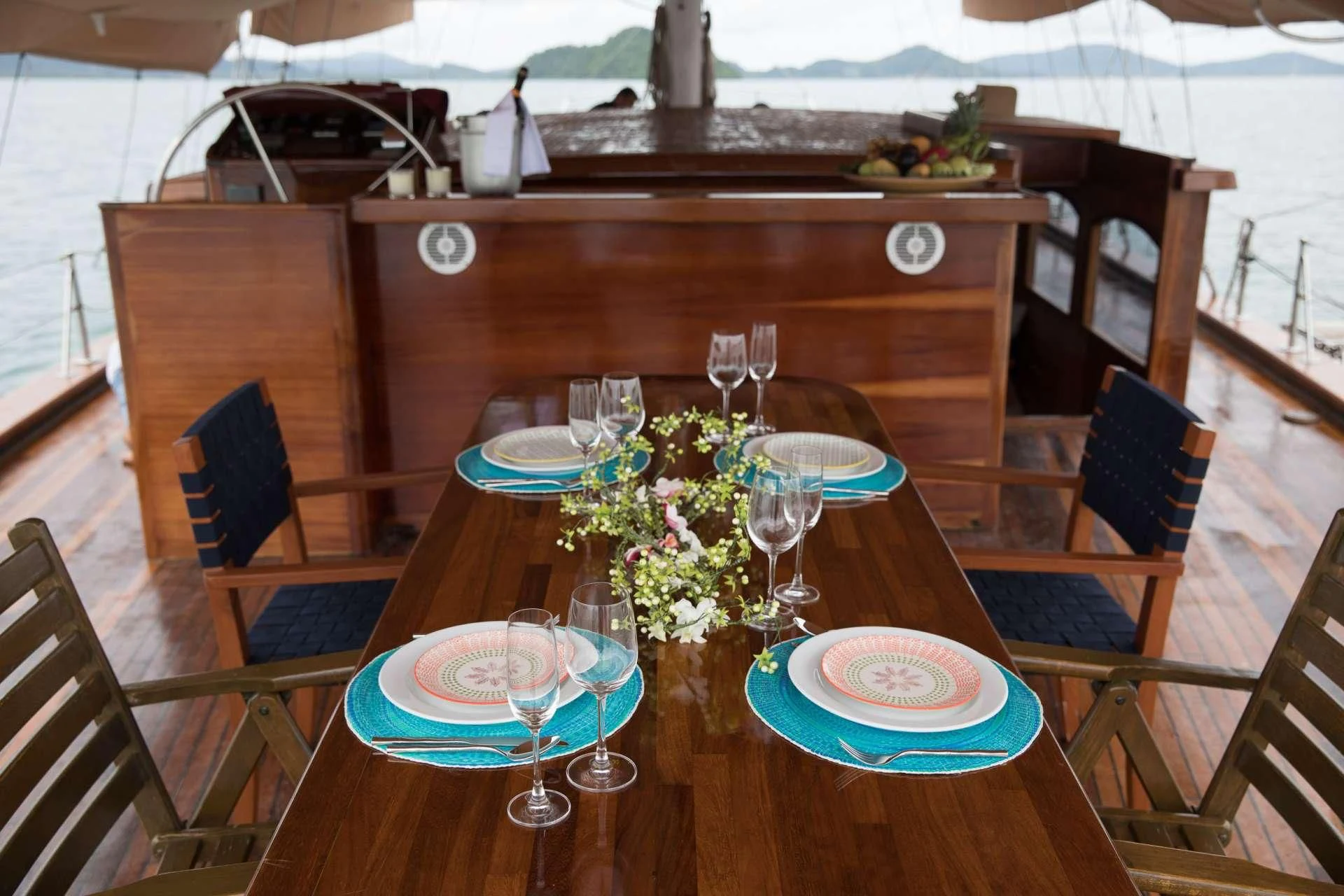 a table with plates and glasses on it aboard THE BLUE Yacht for Sale