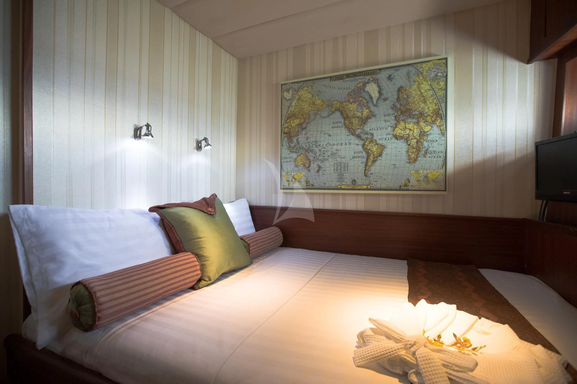 a bed with a painting on the wall aboard THE BLUE Yacht for Sale