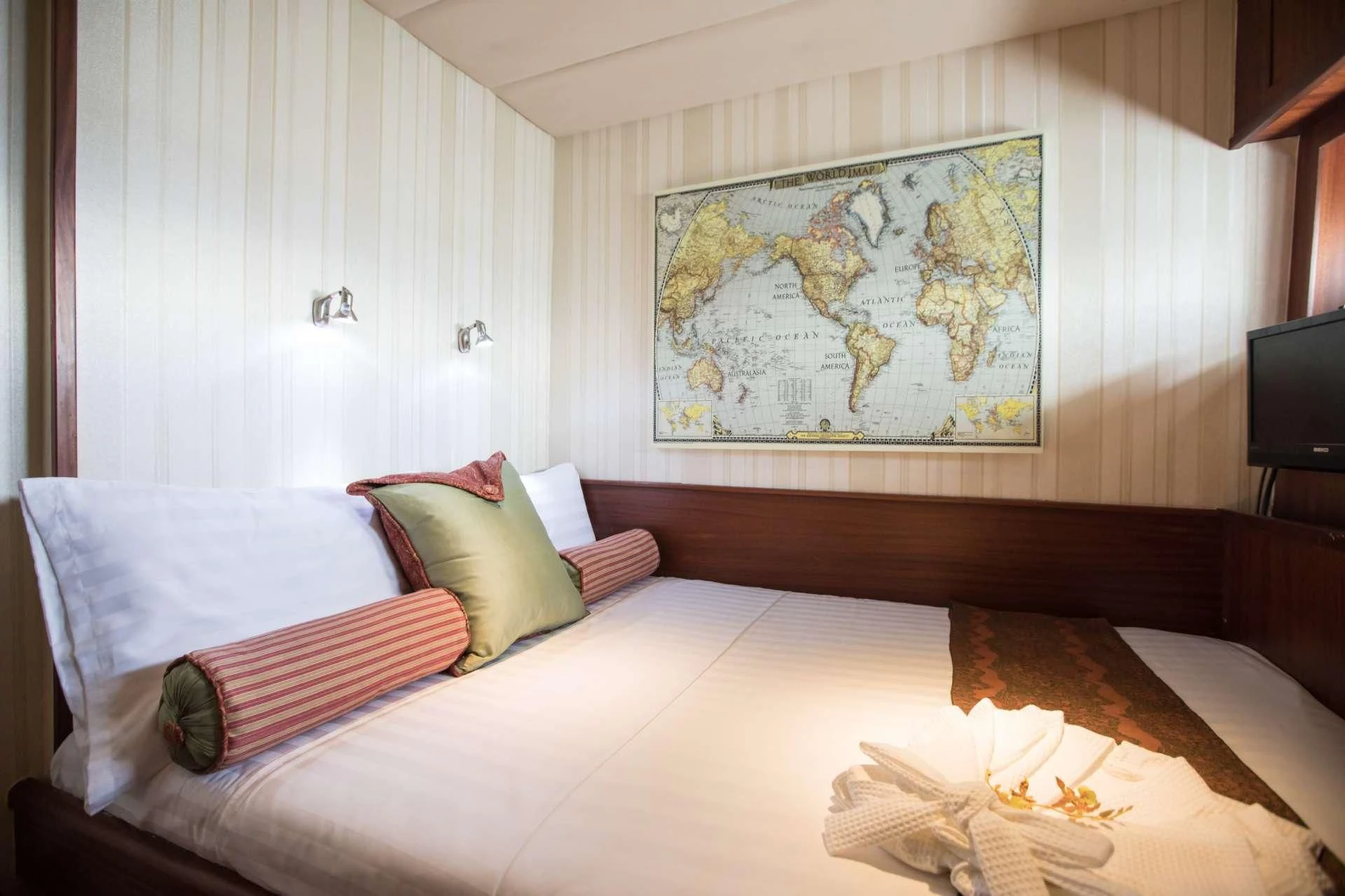 a room with a bed and a painting on the wall aboard THE BLUE Yacht for Sale