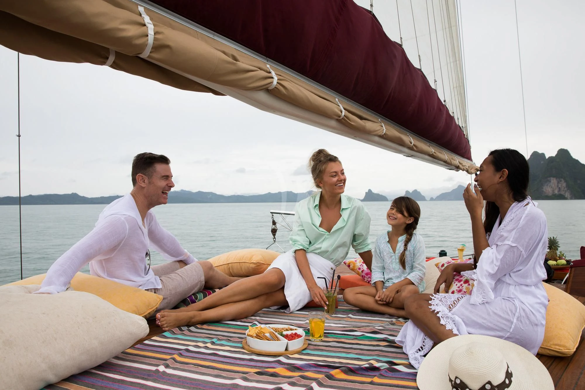 a group of people sitting on a couch under a tent aboard THE BLUE Yacht for Sale