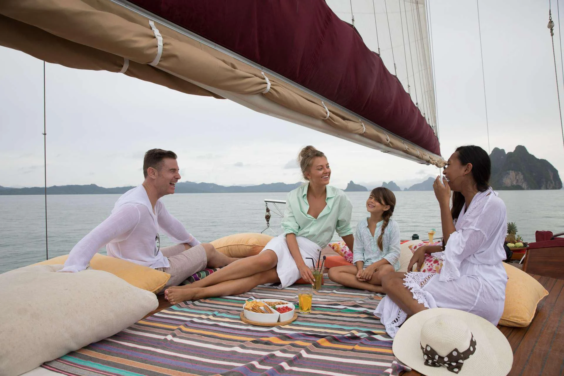 a group of people sitting on a couch aboard THE BLUE Yacht for Sale