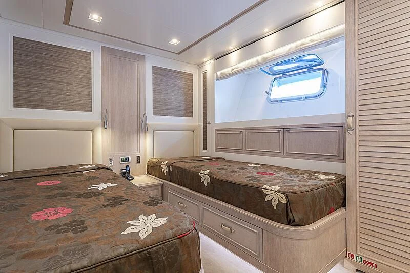 a bedroom with a bed and a window aboard LADY ALINA Yacht for Sale