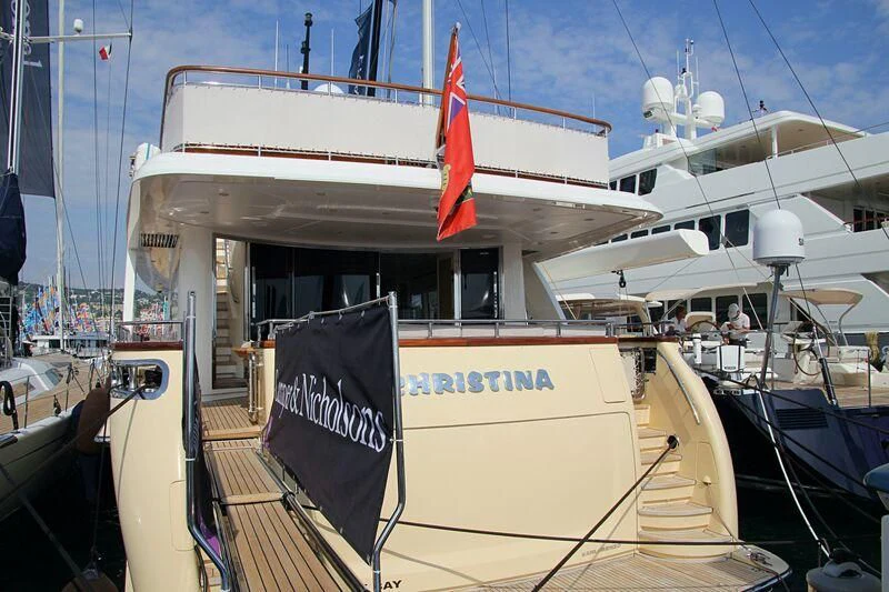 a large white boat with a flag on the front aboard LADY ALINA Yacht for Sale