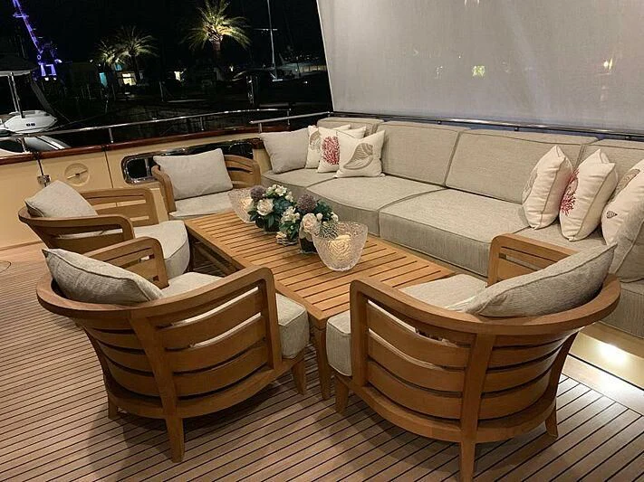 a living room with a couch and a table aboard LADY ALINA Yacht for Sale