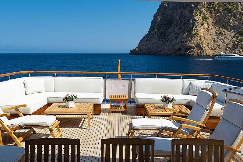a patio with tables and chairs on it by the water aboard LADY ALINA Yacht for Sale