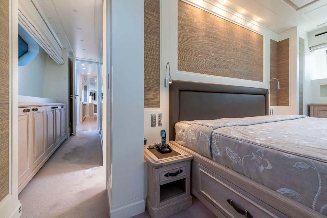 a bedroom with a bed and a dresser aboard LADY ALINA Yacht for Sale