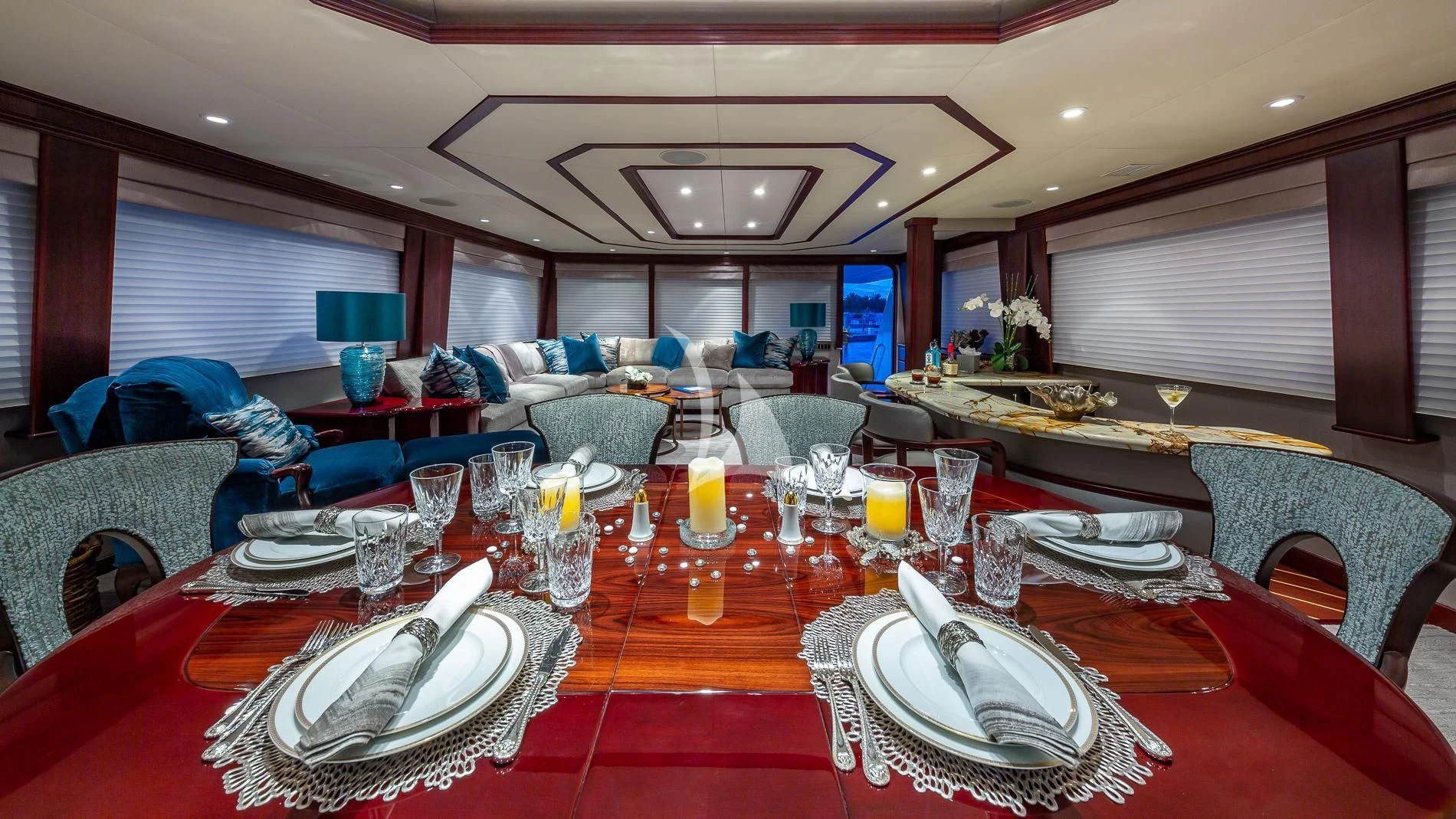 a large dining table with plates and glasses on it aboard DESTINY Yacht for Sale