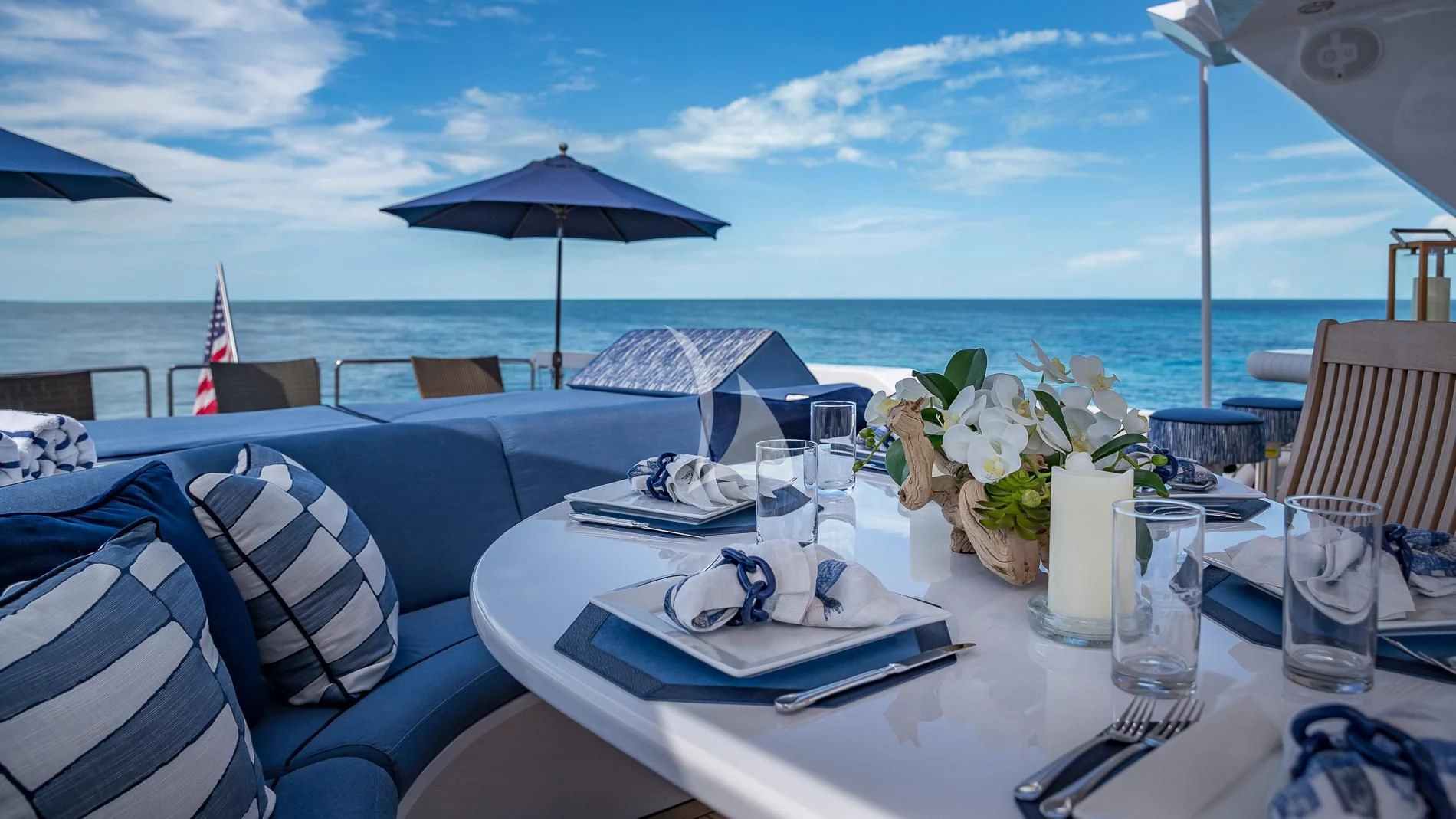 a table with chairs and umbrellas on it aboard DESTINY Yacht for Sale
