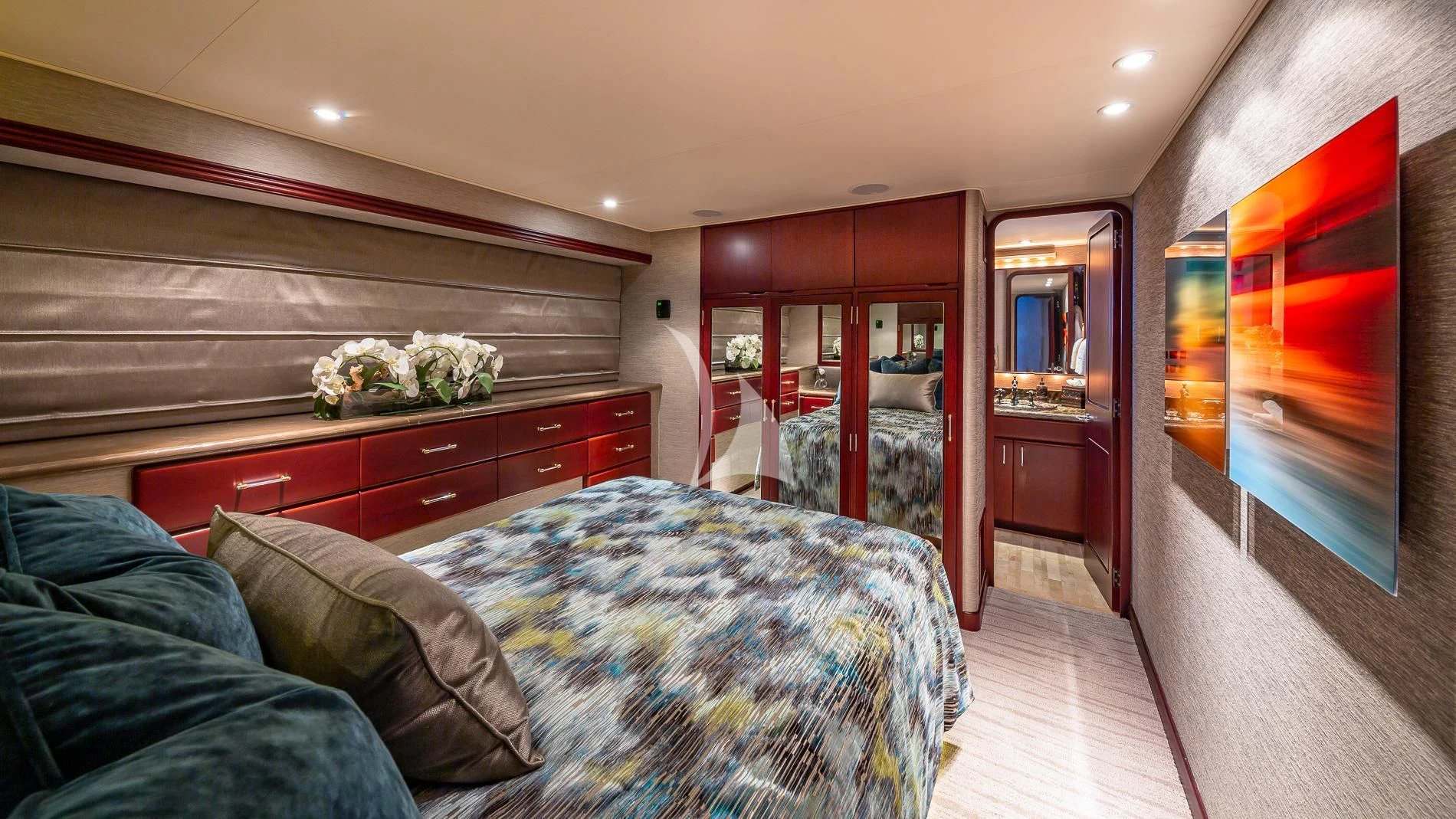 a bedroom with a bed and a dresser aboard DESTINY Yacht for Sale