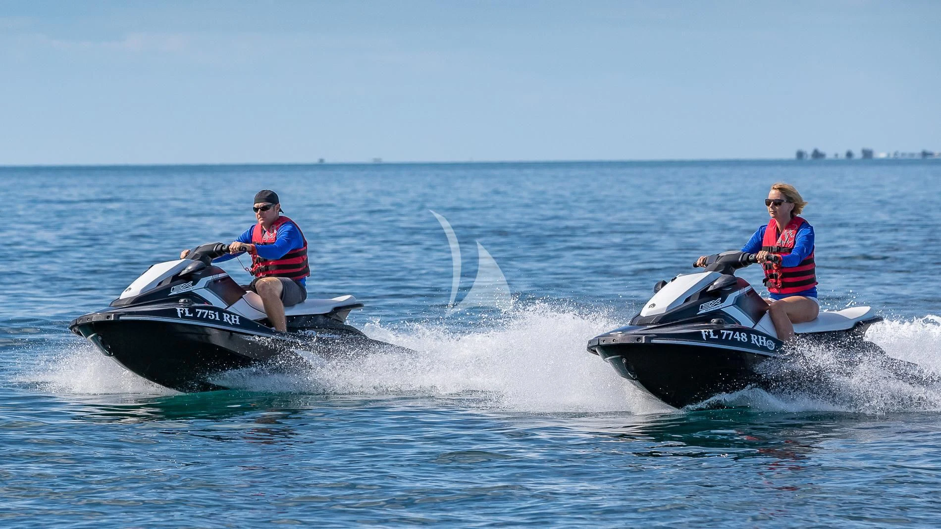 a couple of people on a jet ski in the water aboard DESTINY Yacht for Sale