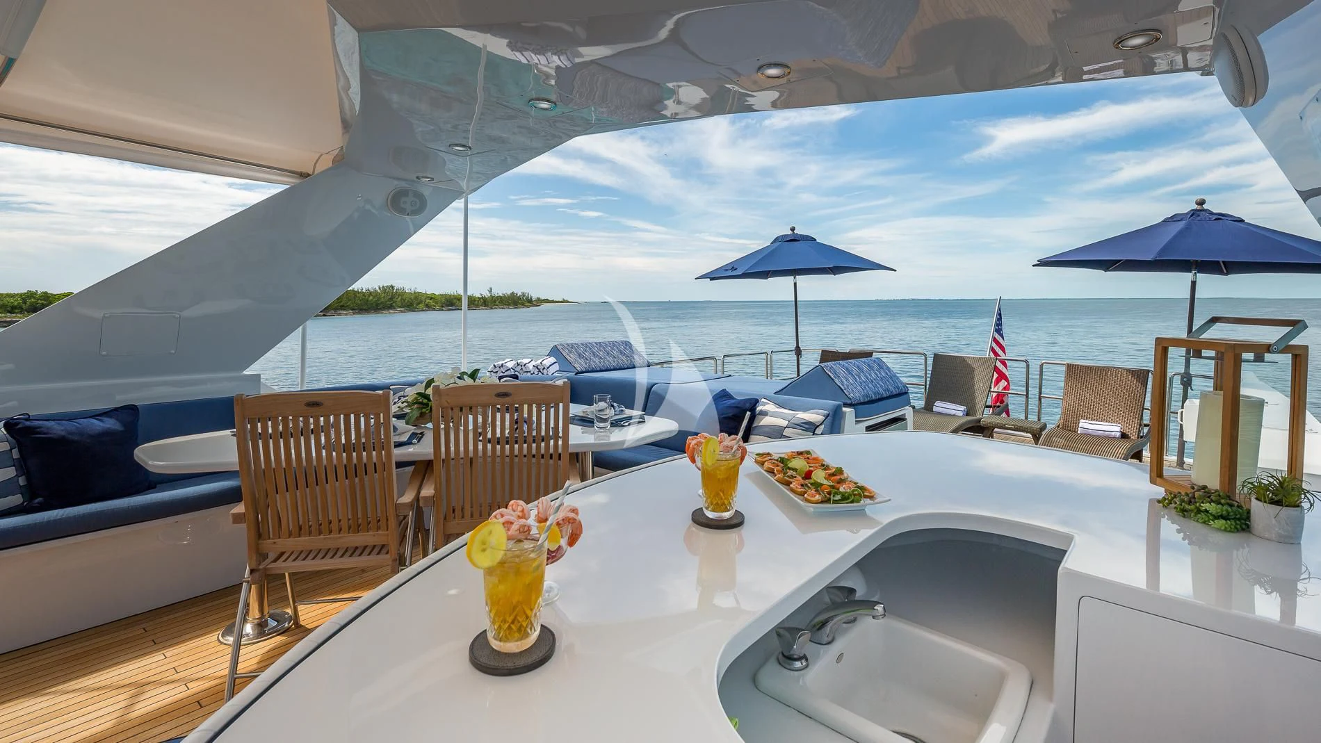 a table with chairs and umbrellas on it aboard DESTINY Yacht for Sale