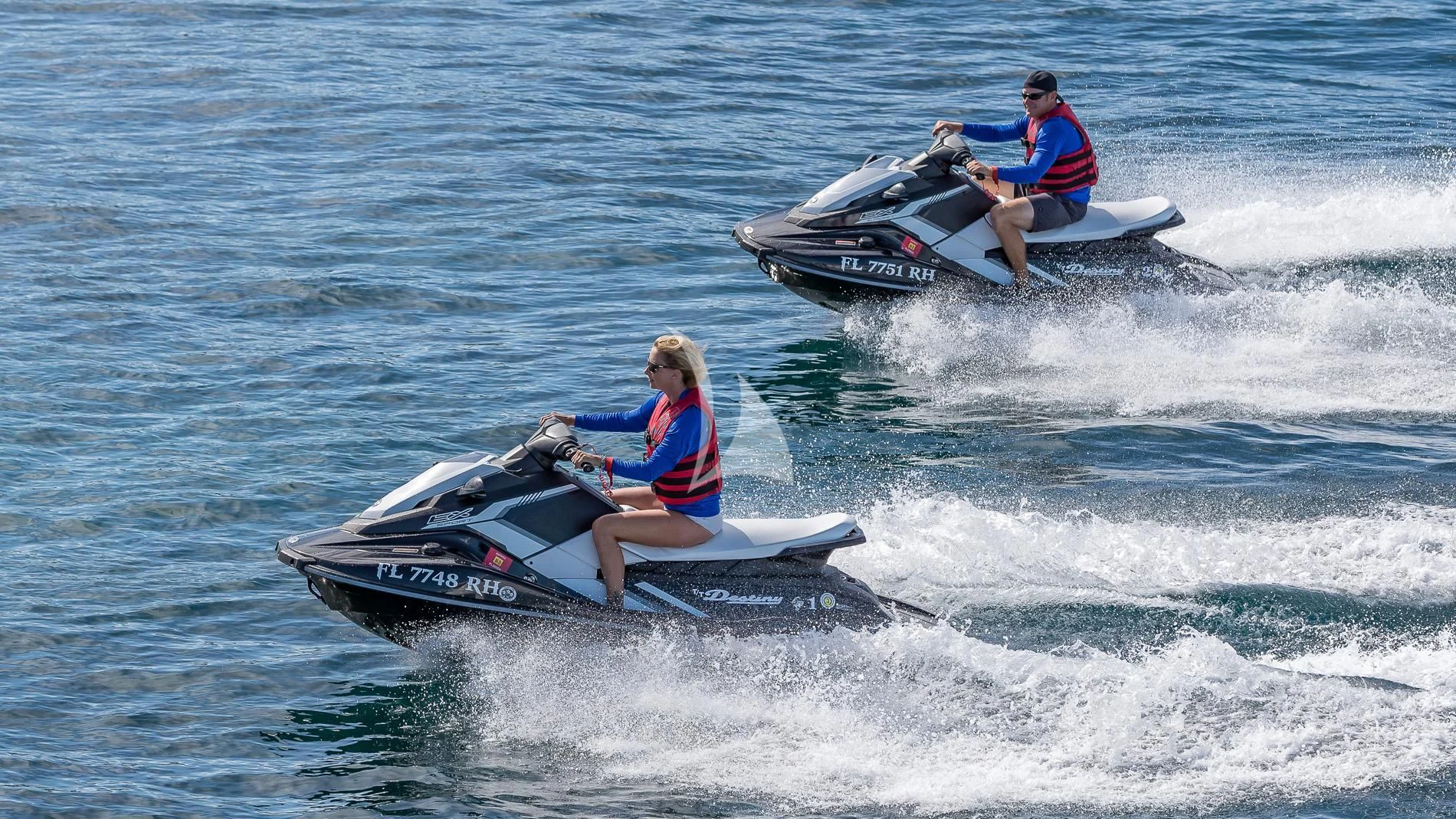 a man and woman in a jet ski aboard DESTINY Yacht for Sale