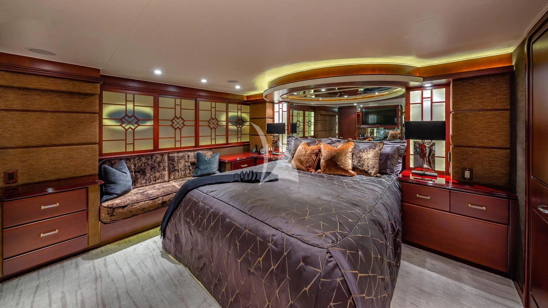a bedroom with a bed and a dresser aboard DESTINY Yacht for Sale