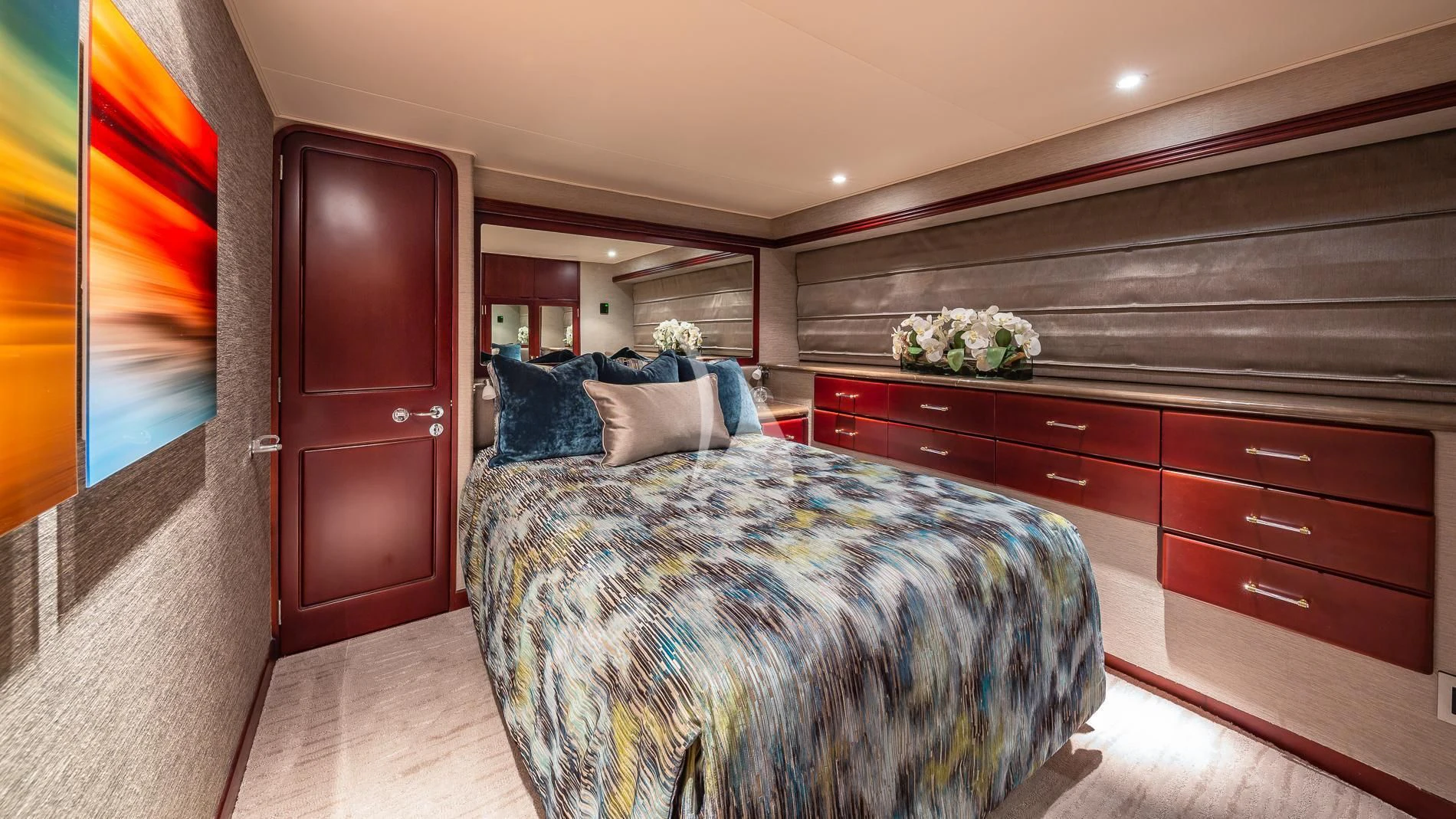 a bedroom with a bed and a dresser aboard DESTINY Yacht for Sale