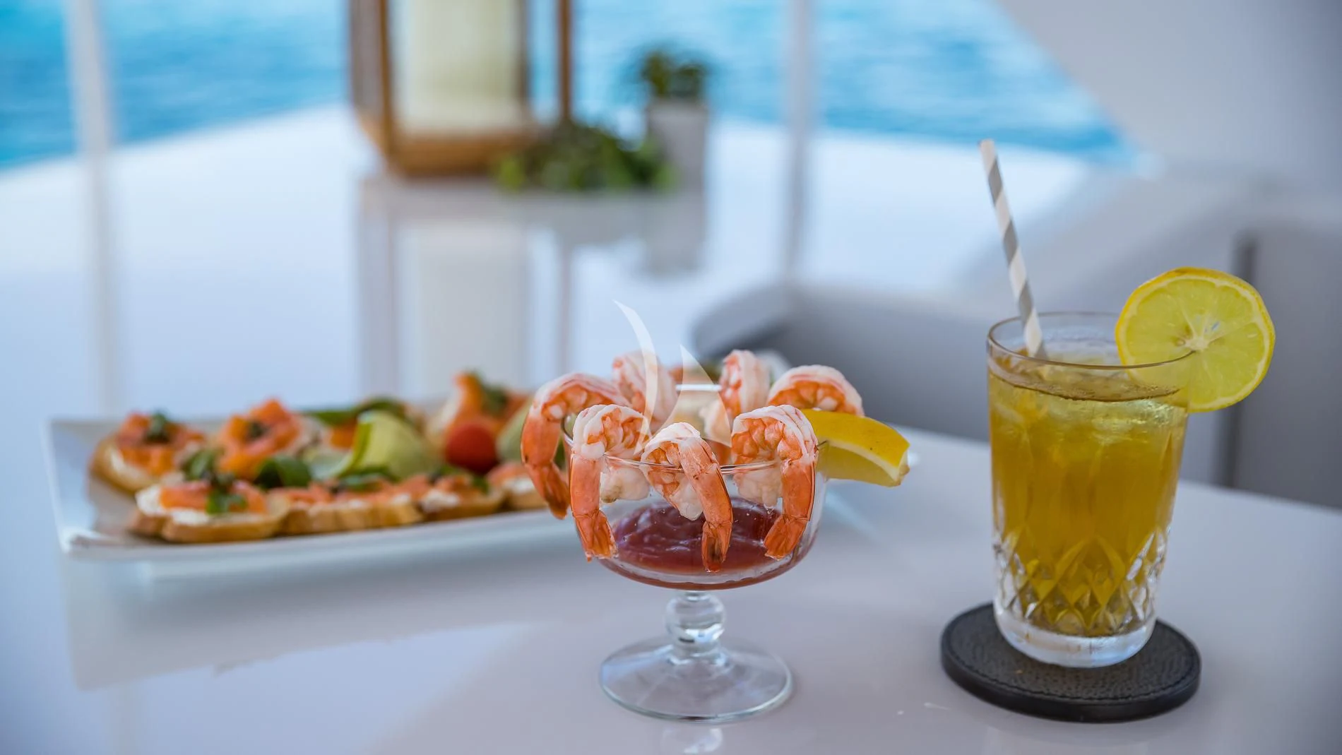 a glass of liquid with a variety of fruits on a table aboard DESTINY Yacht for Sale