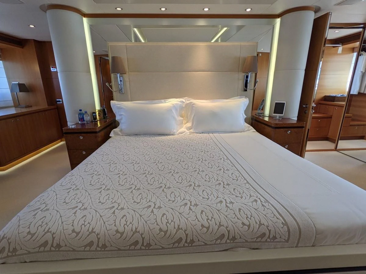 a bed with white sheets aboard MORDAN Yacht for Sale