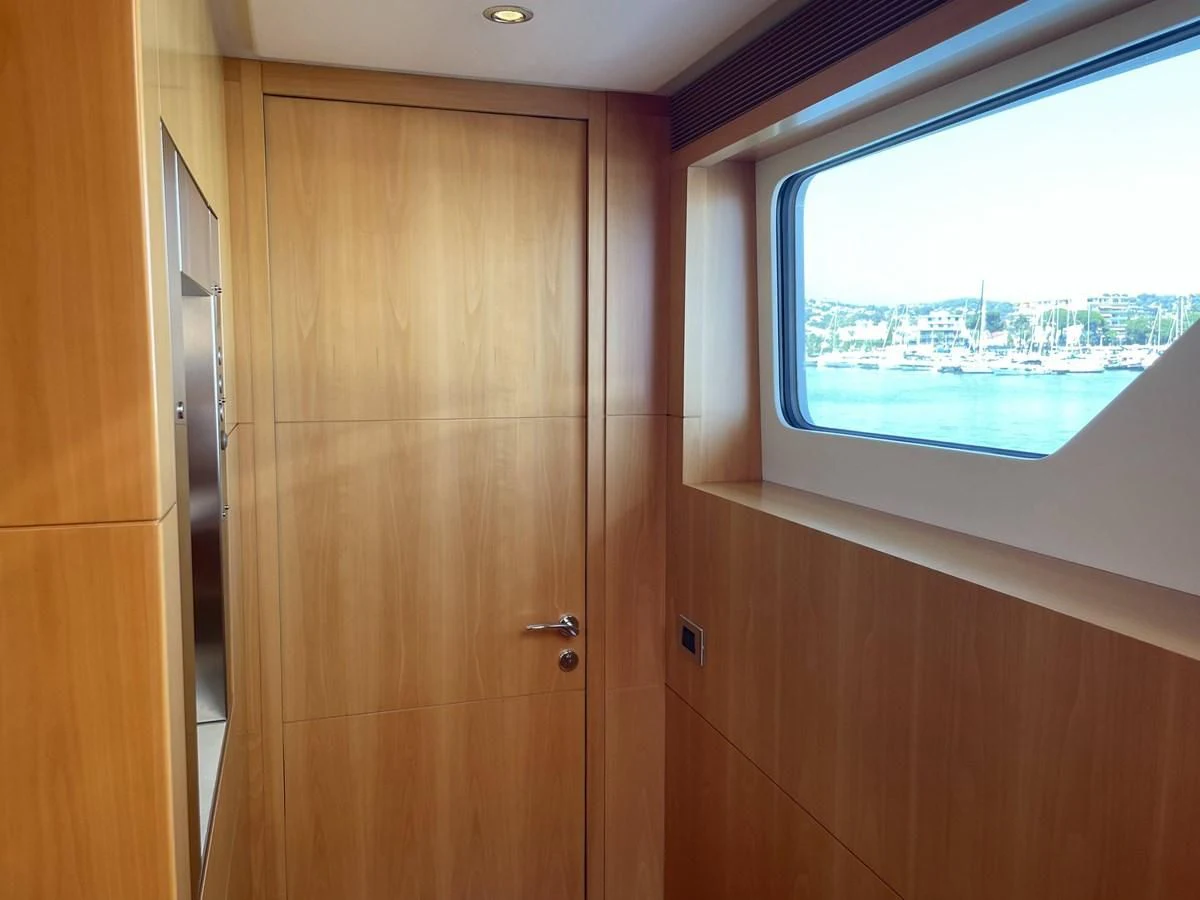 a wooden door with a window aboard MORDAN Yacht for Sale