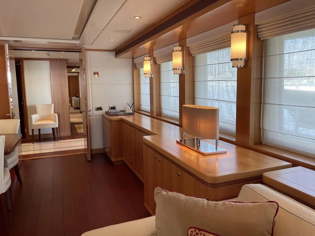 a large room with a wood table and chairs aboard MORDAN Yacht for Sale