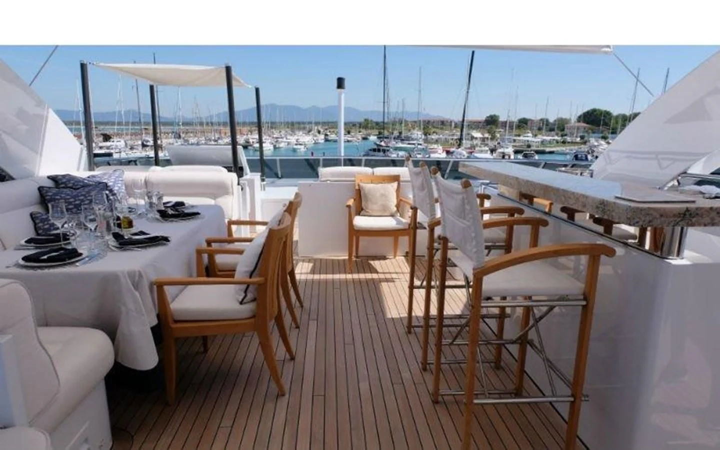 a table and chairs on a balcony aboard MORDAN Yacht for Sale