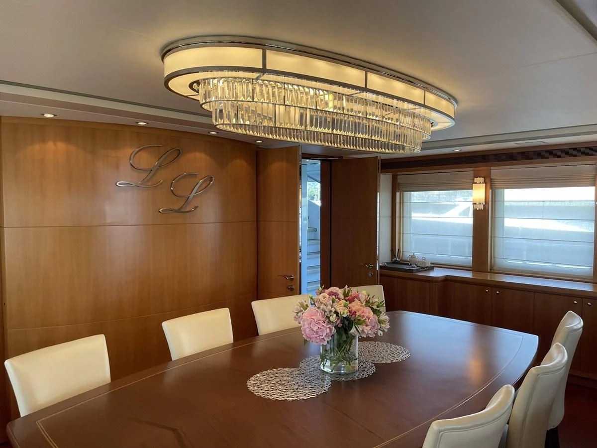a dining room with a chandelier aboard MORDAN Yacht for Sale