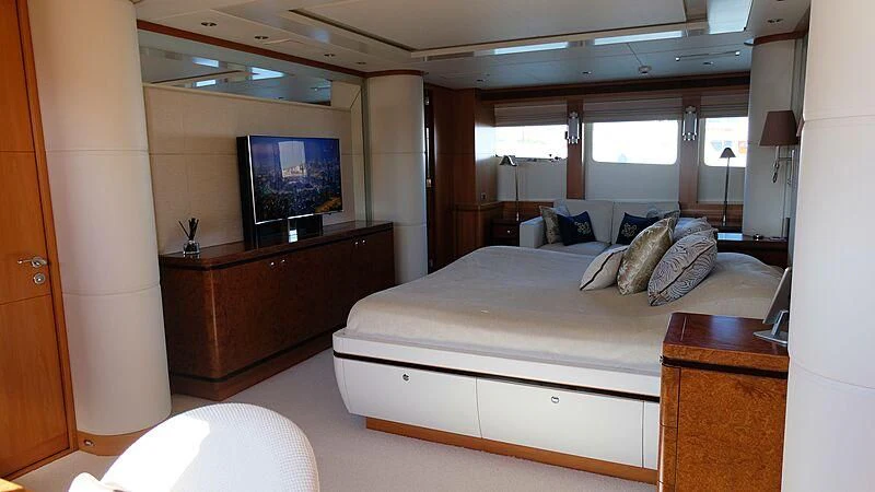 a bedroom with a bed and a desk aboard MORDAN Yacht for Sale