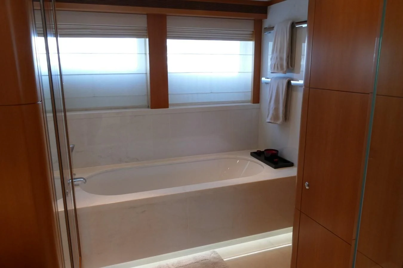 a bathroom with a bathtub and a window aboard MORDAN Yacht for Sale