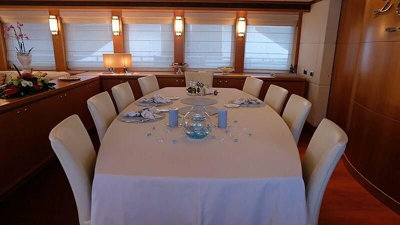 a dining room with a table set aboard MORDAN Yacht for Sale