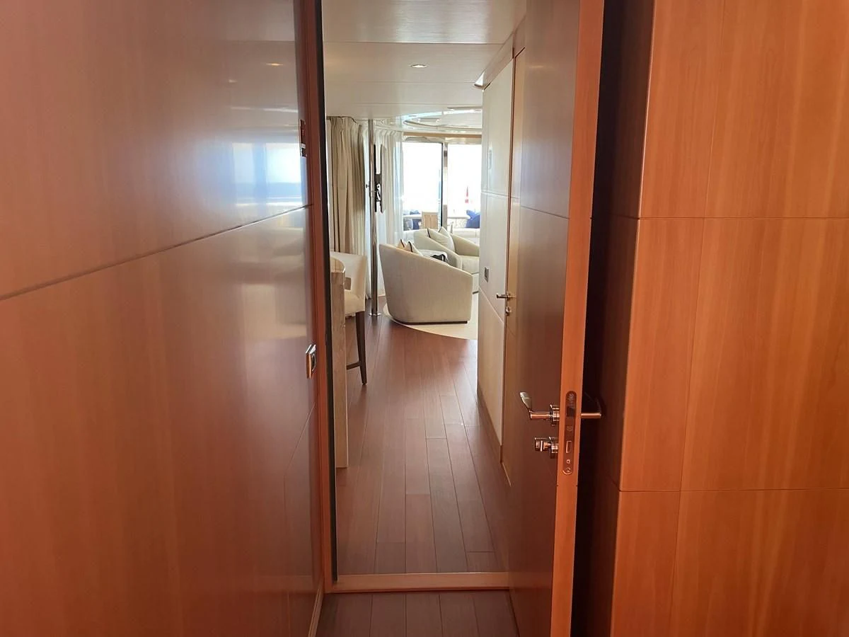 a hallway with a door and a couch aboard MORDAN Yacht for Sale