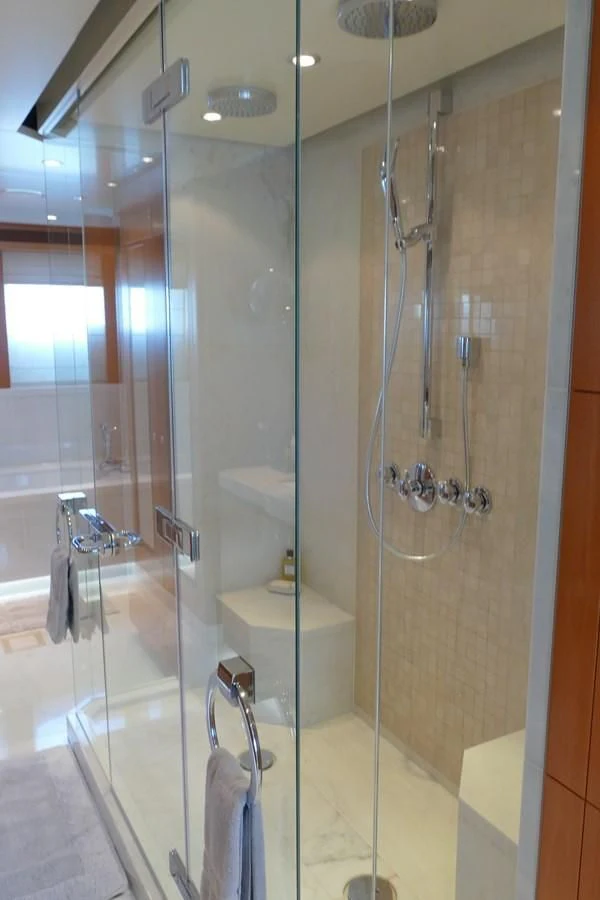 a bathroom with a glass shower aboard MORDAN Yacht for Sale