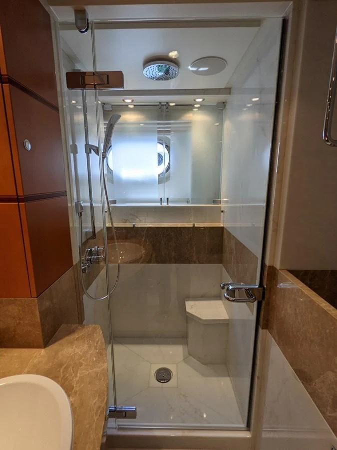 a bathroom with a glass shower aboard MORDAN Yacht for Sale