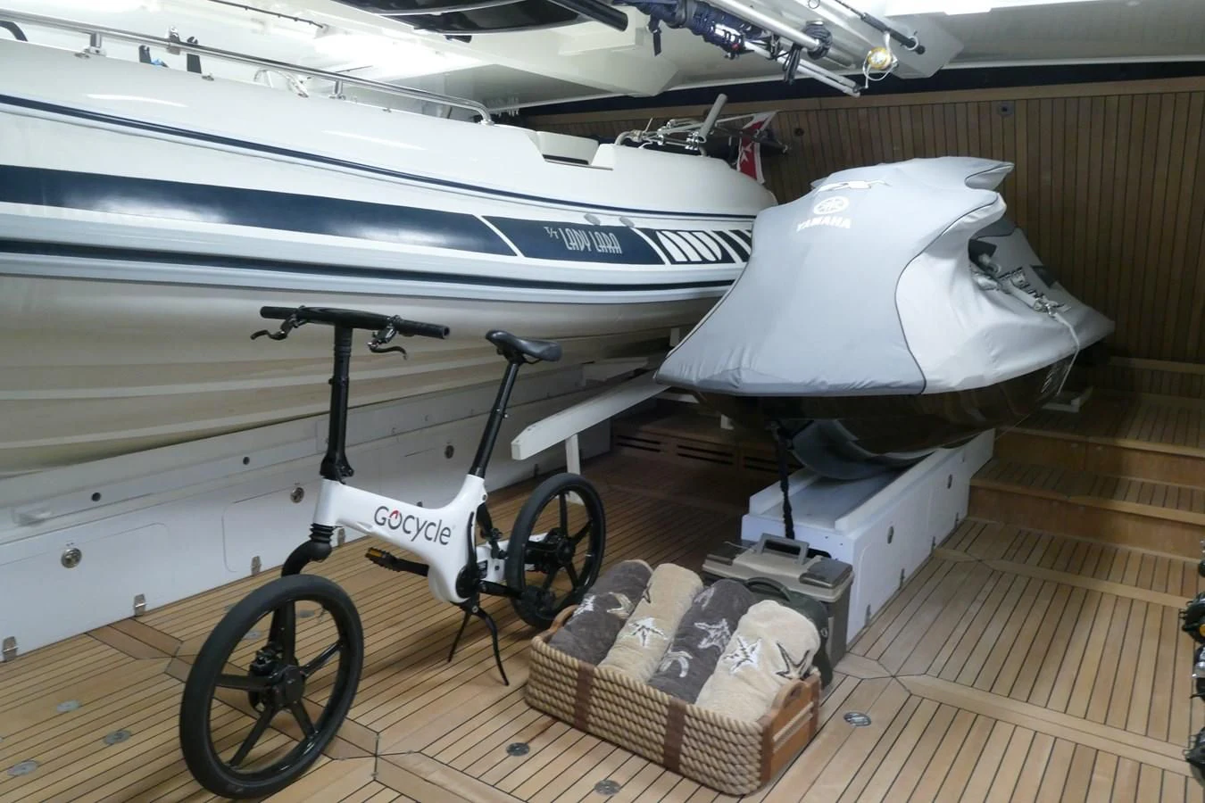 a white boat with a large boat in the background aboard MORDAN Yacht for Sale