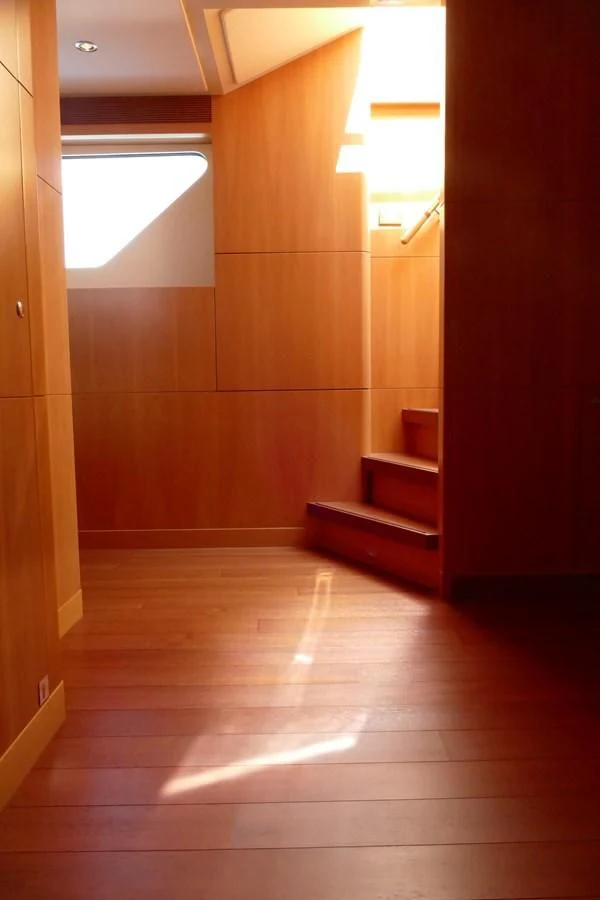 a room with a wood floor and a window aboard MORDAN Yacht for Sale