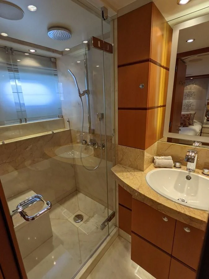 a bathroom with a glass shower aboard MORDAN Yacht for Sale