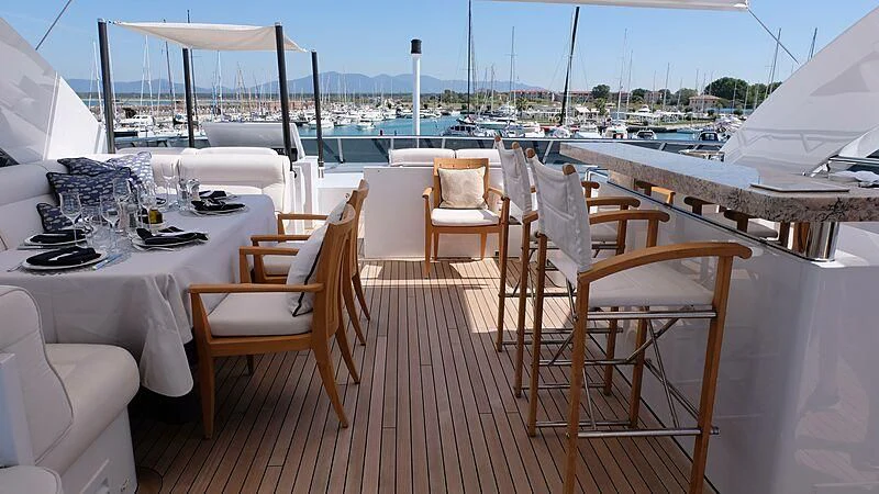 a table set for a dinner on a deck aboard MORDAN Yacht for Sale