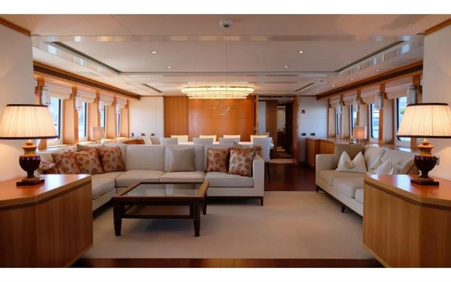 a living room with a large white couch and a large window aboard MORDAN Yacht for Sale