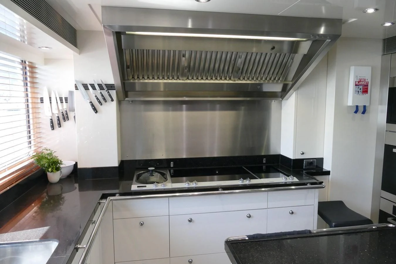 a kitchen with a large steel stove aboard MORDAN Yacht for Sale