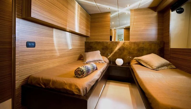 a room with a bed and a window aboard GIOE I Yacht for Sale