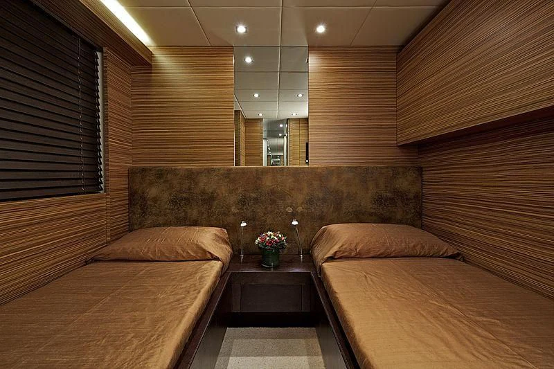 a room with a bed and a table aboard GIOE I Yacht for Sale