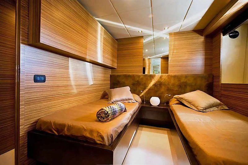 a room with a bed and a couch aboard GIOE I Yacht for Sale